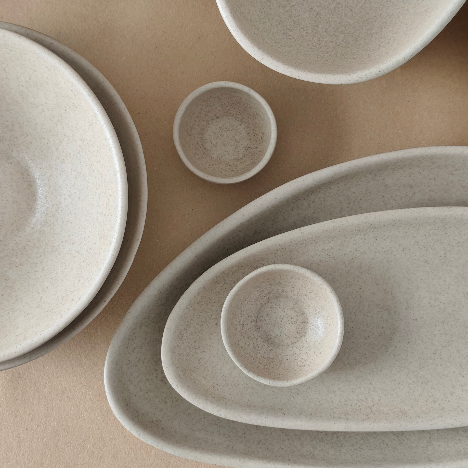 Vajilla de gres Jade Haus: platos, fuentes y bowls en tono arena moteado